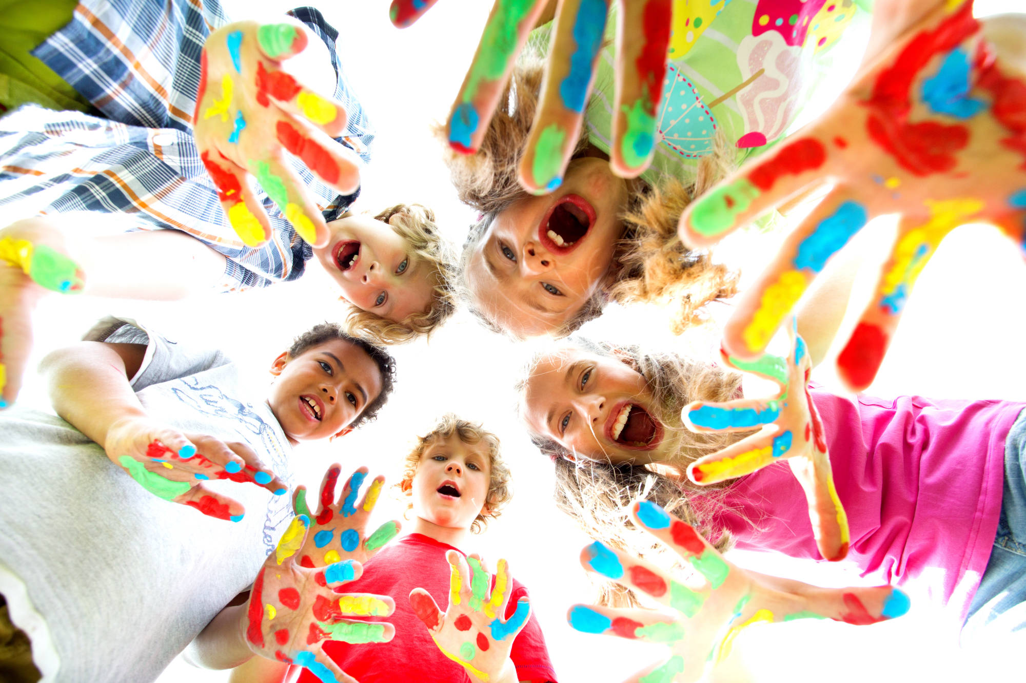Children with painted hands smiling